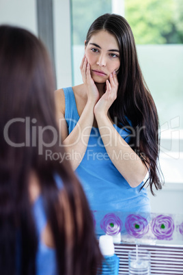 Sad brunette in bathroom