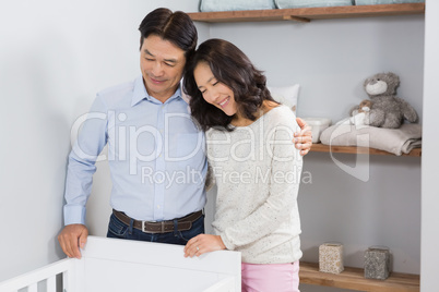 Happy couple looking in crib