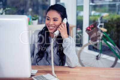 Smiling Asian woman on phone call