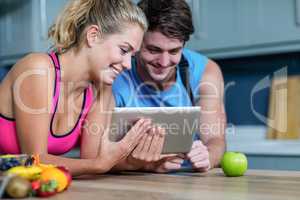 Healthy couple looking at tablet