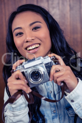 Asian woman holding digital camera