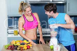 Healthy couple preparing a smoothie