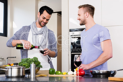 smiling gay couple preparing food