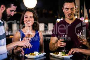 Friends having an aperitif with wine