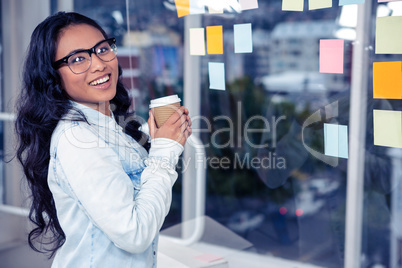 Asian woman holding disposable cup