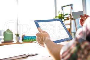 Cropped image of hipster businessman using tablet and credit car
