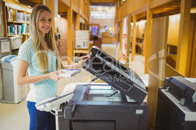 Smiling blonde student making a copy