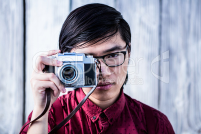 Hipster taking pictures with an old camera