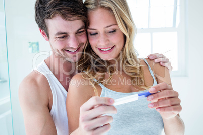 Happy couple looking at pregnancy test