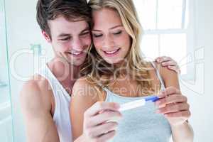 Happy couple looking at pregnancy test