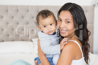 Happy brunette holding her baby