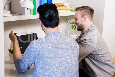 Happy gay couple using laptop