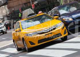 Classic street view with yellow cab in New York city