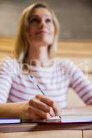 Female student taking notes in a class