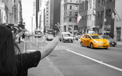 Tourist call a yellow cab in Manhattan with typical gesture