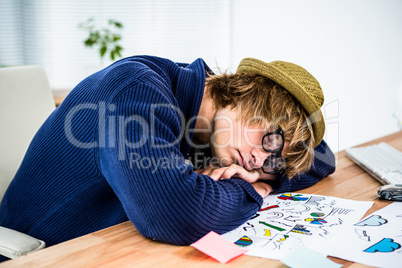 Hipster businessman sleeping at his desk