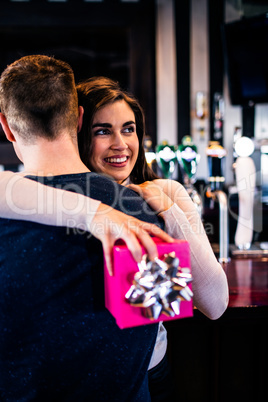 Couple hugging in a bar