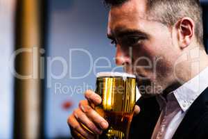 Businessman drinking beer