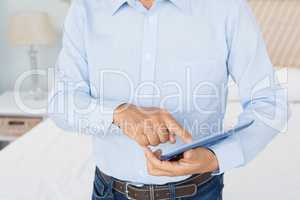 Mid section of man using tablet