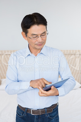 Serious man using tablet