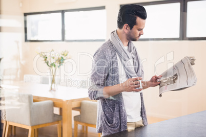 Handsome man reading newspaper