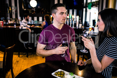 Couple having an aperitif with wine