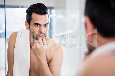 Handsome man looking in mirror