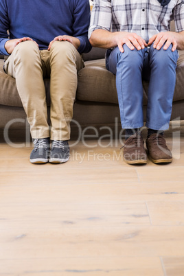 Gay couple relaxing on the couch