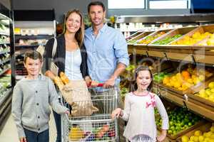 Cute family choosing groceries together