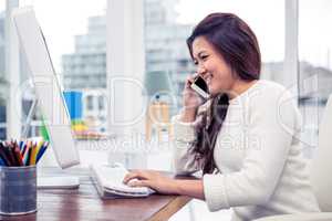 Businesswoman on phone call using computer
