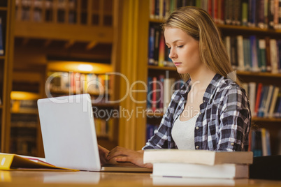 Serious student working on laptop