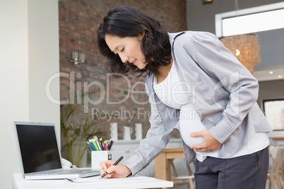 Pregnant woman reading documents
