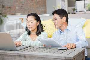 Worried couple checking bills