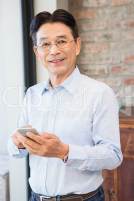 Smiling man using smartphone