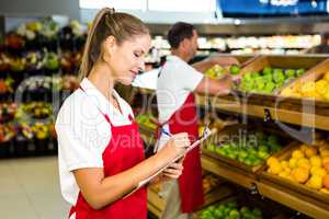 Grocery store staff with clipboard