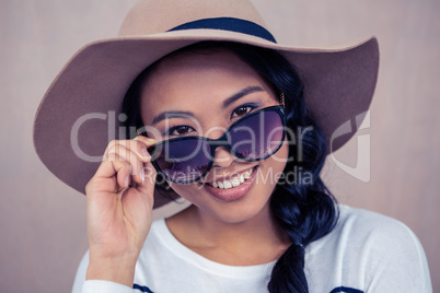 Smiling Asian woman with hat and sunglasses