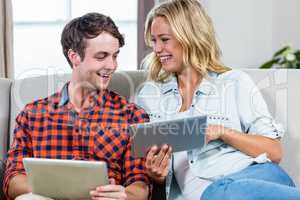 Couple using tablet computers