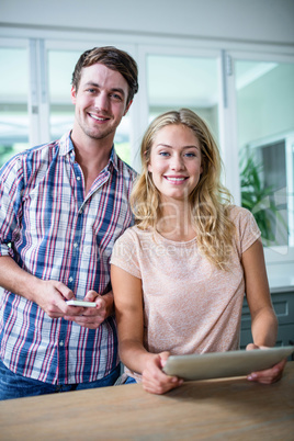 Cute couple using tablet computer in the kitchen Cute couple using tablet computer in the kitchen