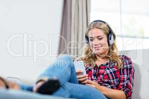 Woman listening to music on the couch