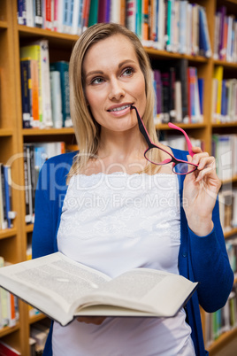 Thoughtful female student holding a book Thoughtful female student holding a book