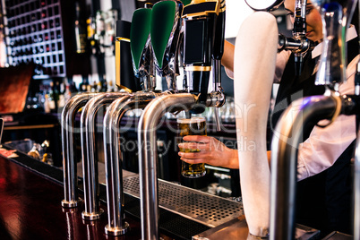 Barmaid serving a pint