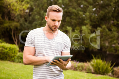 Thoughtful man using tablet