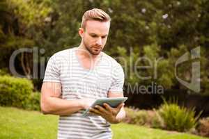 Thoughtful man using tablet