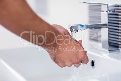 Close up of washing hands under running water