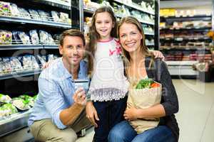 Portrait of family showing credit card