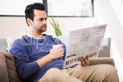 Handsome man reading the news