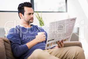 Handsome man reading the news