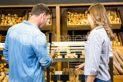 Happy couple looking at bread