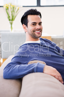 Handsome man day dreaming on the couch