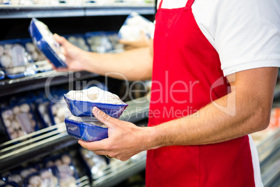 Male worker holding mushroom